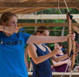 girl in blue iawah shirt aiming her arrow.