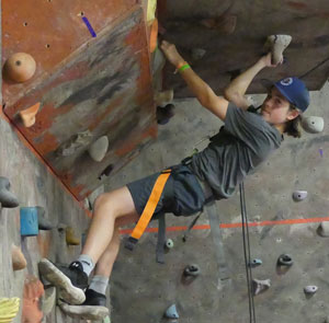 boy climbing on an indoor climbing wall