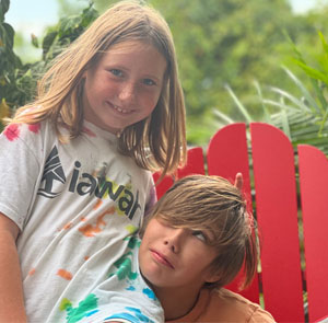 two youths with camp IAWAH tie-dyed t-shirts on